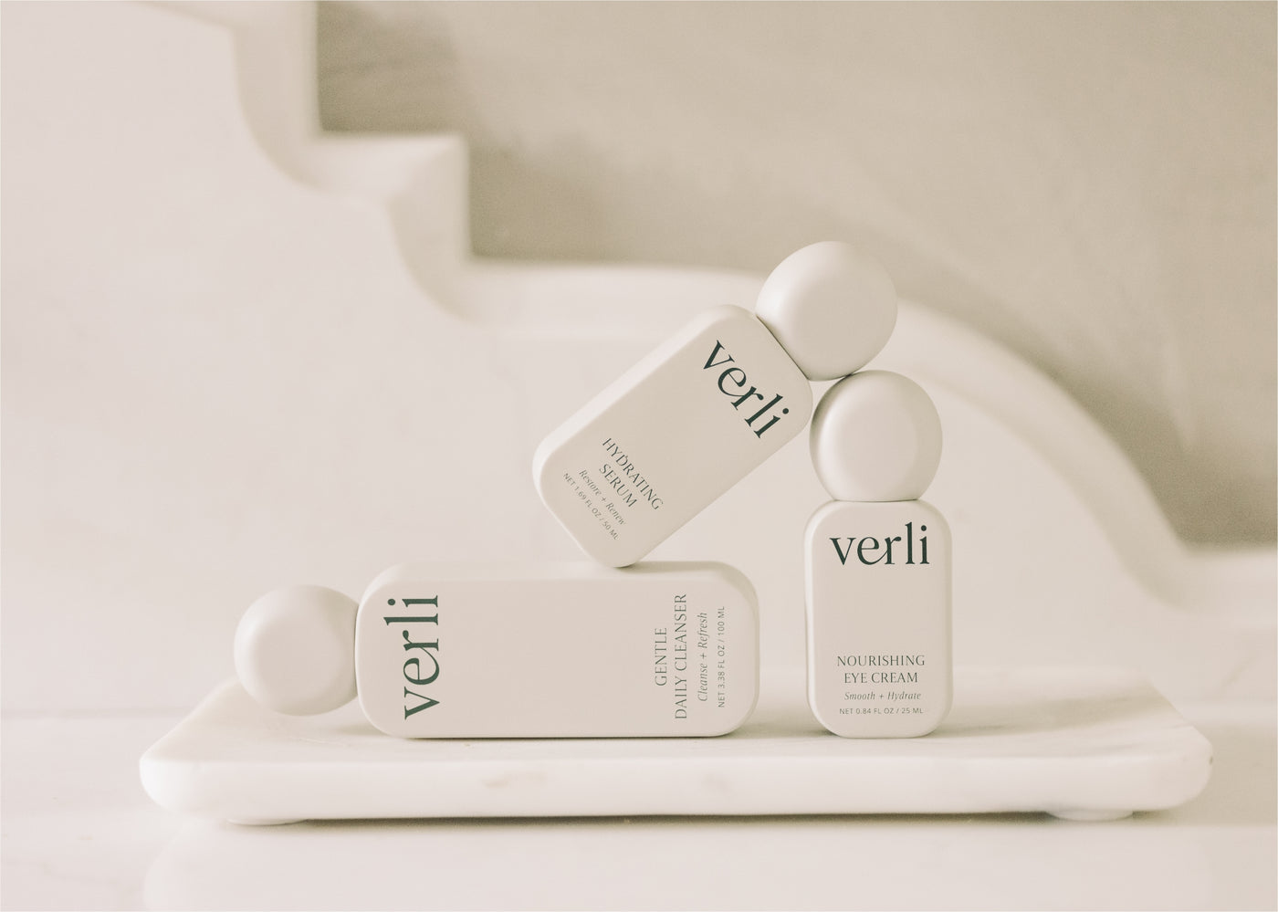 Verli skincare products on a marble surface with a neutral background